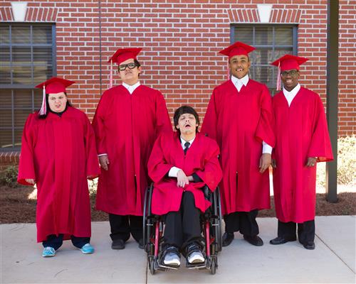5 students in graduation gowns 